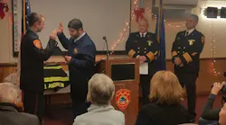 Middletown probationary firefighter Owen Andrew, left, is officially sworn in on Monday. Dec. 10, 2018.