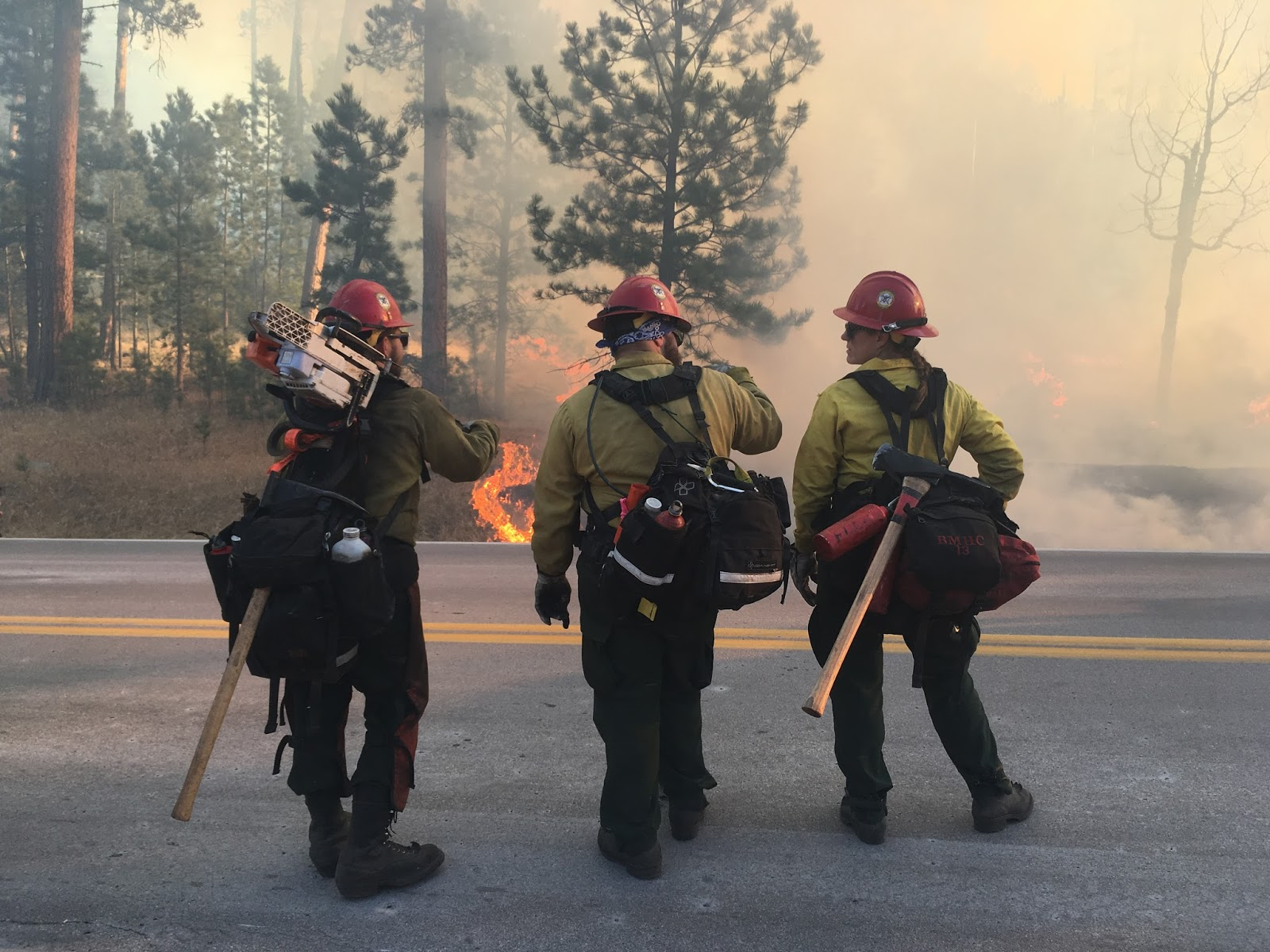 Three firefighters monitor the Legion Lake Fire in December 2017.