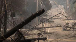 Power poles and lines block a street at Brookdale and Aaron Dr. in Hidden Valley, CA, where most of the homes were destroyed by fire in Santa Rosa on Oct. 9, 2017.