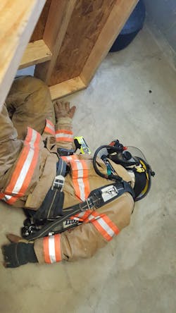 In the Air Supply drill, a firefighter victim lays on their side in a room and initiates a mayday for critically low SCBA air levels.