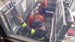 Firefighters rescued two workers who were stuck in a Grand Rapids City Hall elevator six stories up Thursday.