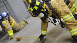Haddam Volunteer Fire Company firefighters run the &apos;Jeff&apos;s Box&apos; drill, a training exercise that involves working blindfolded with a partner to identify objects in an area.