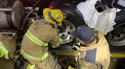Livonia firefighters rescued a person trapped between two tractor-trailer tires Thursday night in Plymouth Township, MI.