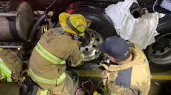 Livonia firefighters rescued a person trapped between two tractor-trailer tires Thursday night in Plymouth Township, MI.