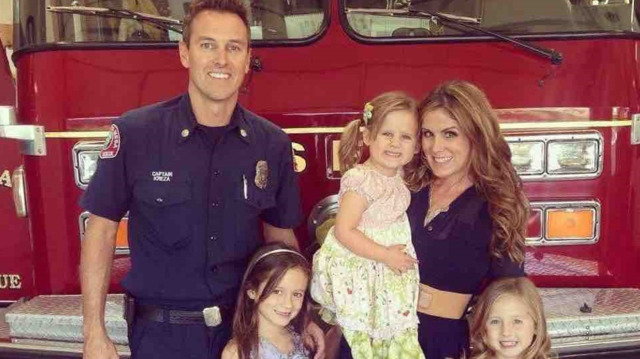 Costa Mesa, CA, fire Capt. Mike Kreza (left) with his wife and three young daughters.