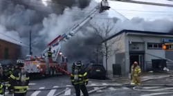More than 100 FDNY firefighters battled frigid temperatures Monday as they worked to put out a fire at a toy and medical supply company in Queens.