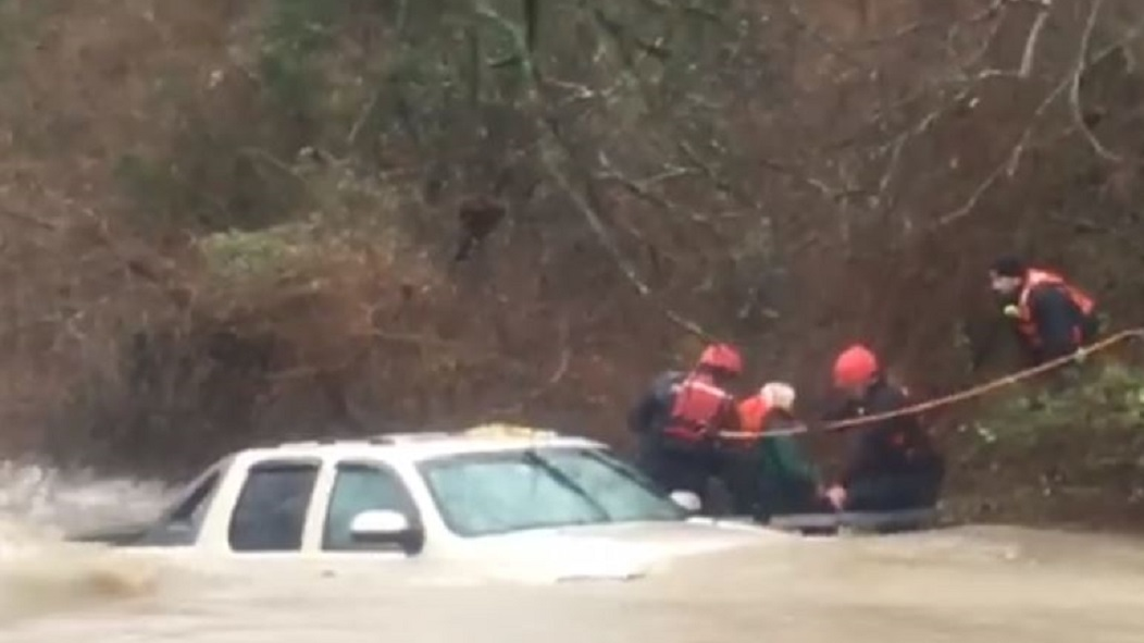 Temple firefighters rescue an elderly driver from his truck after he was swept downstream while trying to navigate a low water crossing.