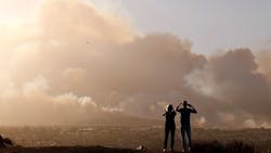 Derek and Linda Oliver watch smoke from the fast-moving Hill fire in Thousand Oaks, CA, on Nov. 8, 2018. Derek and Linda Oliver watch smoke from the fast-moving Hill fire in Thousand Oaks, CA, on Nov. 8, 2018.