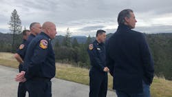 California Gov. Gavin Newsom, right, tours wildfire-affected areas of the Sierra foothills with CAL FIRE personnel on Tuesday, Jan. 8, 2019.