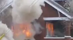 Decatur firefighters had a close call as flames erupted through an outside window as they battled a house fire.