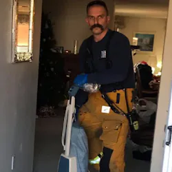 Santee Capt. Chris Thompson vacuums tracked-in mud at a home following a medical emergency call New Year's Day. Santee Capt. Chris Thompson vacuums tracked-in mud at a home following a medical emergency call New Year's Day.