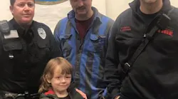 Six-year-old Johnny Taylor with, from left, Black Mountain Police Sgt. Nickey Guffey and Black Mountain firefighters Austin Edwards and Ray Buchanan.