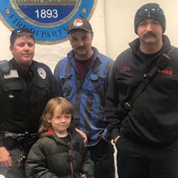 Six-year-old Johnny Taylor with, from left, Black Mountain Police Sgt. Nickey Guffey and Black Mountain firefighters Austin Edwards and Ray Buchanan.