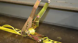 After tightening a ratchet tie-down unit as fully as necessary by hand, rescuers should close the handle, so it latches over the sprocket slide bar and secures the mandrel core in position.
