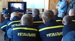 Ukrainian firefighters take in a classroom session on wildland fire suppression before heading out for hands-on training.