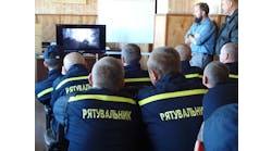Ukrainian firefighters take in a classroom session on wildland fire suppression before heading out for hands-on training.