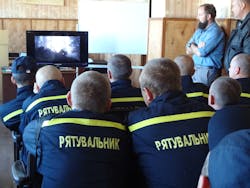 Ukrainian firefighters take in a classroom session on wildland fire suppression before heading out for hands-on training.
