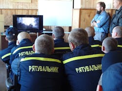 Ukrainian firefighters take in a classroom session on wildland fire suppression before heading out for hands-on training. Ukrainian firefighters take in a classroom session on wildland fire suppression before heading out for hands-on training.