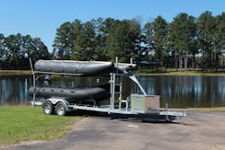An example of a double-stacked trailer with both military-style and pontoon-style rescue boats for various mission types.