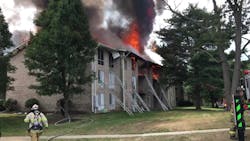 The rear side of the building shows fire from and near the apartment of origin. The trench cut was in progress at this time. The rear side of the building shows fire from and near the apartment of origin. The trench cut was in progress at this time.