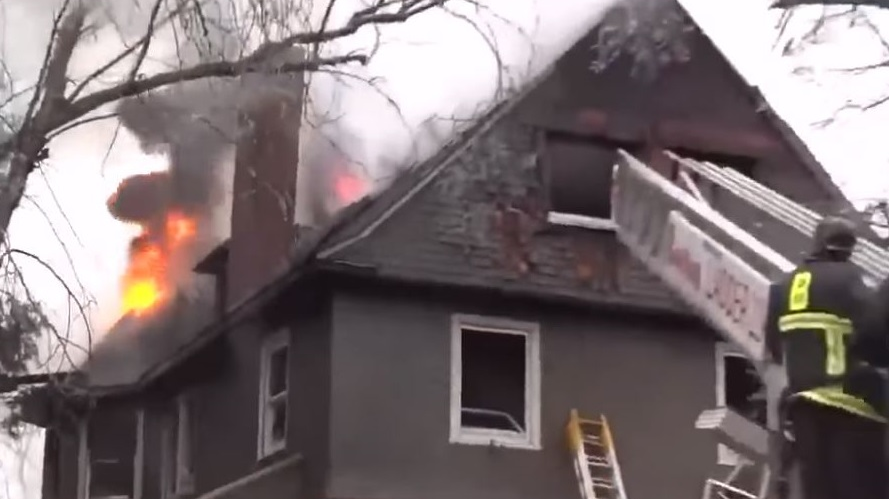 Boston firefighters battled a 'very difficult' five-alarm fire at a home in Roxbury on Tuesday.