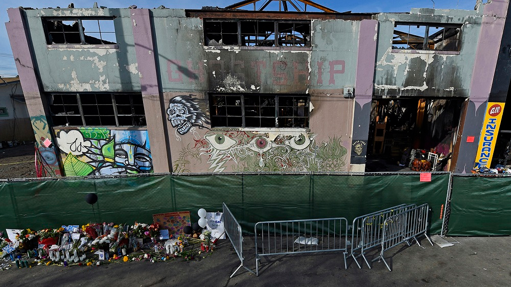 The view outside the scorched Ghost Ship warehouse building in Oakland, CA. The blaze tore through the two-story building on the 1300 block of 31st Avenue, killing 36 people.