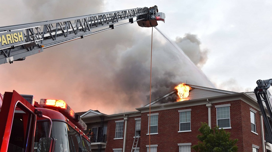 A Jefferson Parish East Bank firefighter suffered burns after falling through an apartment building roof while battling a fire Saturday.