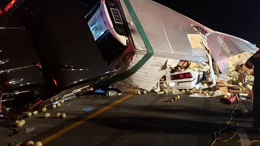 Marion County, FL, firefighters rescued two people trapped in their car after a tractor-trailer flipped on top of it Thursday night.