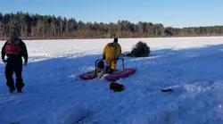 Sudbury, MA, firefighters used a sled to help rescue a cross-country skier who fell through a frozen lake Tuesday.