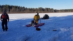 Sudbury, MA, firefighters used a sled to help rescue a cross-country skier who fell through a frozen lake Tuesday. Sudbury, MA, firefighters used a sled to help rescue a cross-country skier who fell through a frozen lake Tuesday.