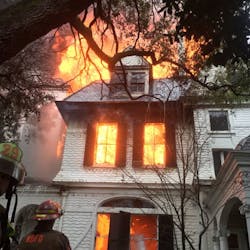 New Orleans firefighters battled a multiple-alarm blaze Wednesday that tore through a three-story, Victorian-style mansion that had been in the same family for more than 100 years.
