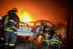 Firefighters begin the fire attack low to the ground with a 2½-inch hoseline. Firefighters begin the fire attack low to the ground with a 2½-inch hoseline.