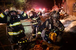 Firefighters equipped with search ropes don their SCBA and prepare to conduct a search of the fire building. Firefighters equipped with search ropes don their SCBA and prepare to conduct a search of the fire building.