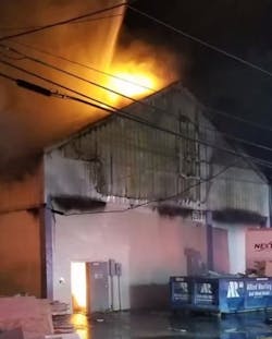 Nearly 40 firefighters from nine departments battled a three-alarm warehouse blaze Wednesday night in Tamarac, FL.
