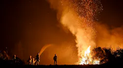 California firefighters monitor an Aug. 7 burn operation on top of a ridge near the town of Ladoga.