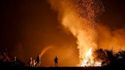 California firefighters monitor an Aug. 7 burn operation on top of a ridge near the town of Ladoga. California firefighters monitor an Aug. 7 burn operation on top of a ridge near the town of Ladoga.
