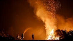 California firefighters monitor an Aug. 7 burn operation on top of a ridge near the town of Ladoga. California firefighters monitor an Aug. 7 burn operation on top of a ridge near the town of Ladoga.