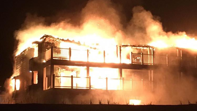 Flames shot 40 feet high as 60 firefighters and 25 pieces of apparatus from 16 departments battled the blaze that broke out at an Oak Island, NC, motel Sunday night.