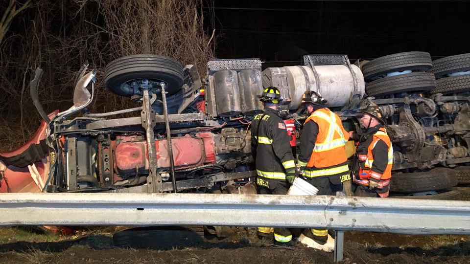 Westport and Fairfield firefighters rescued a truck driver who was trapped in his overturned tractor-trailer Thursday.
