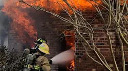 Suffolk crews rescued a firefighter trapped under rubble from a wall that collapsed on her while battling a rural home blaze Monday morning.