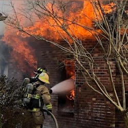 Suffolk crews rescued a firefighter trapped under rubble from a wall that collapsed on her while battling a rural home blaze Monday morning.