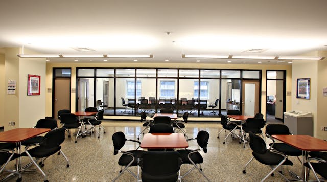 The renovated District of Columbia Engine Co. 16 features a training conference center that has wood cabinets and furniture, a renovated skylight, and interior glass panels that allow views through adjacent spaces to the outside. This strategy also allows daylight to penetrate deeply inside the building to create an uplifting work environment.