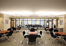 The renovated District of Columbia Engine Co. 16 features a training conference center that has wood cabinets and furniture, a renovated skylight, and interior glass panels that allow views through adjacent spaces to the outside. This strategy also allows daylight to penetrate deeply inside the building to create an uplifting work environment.