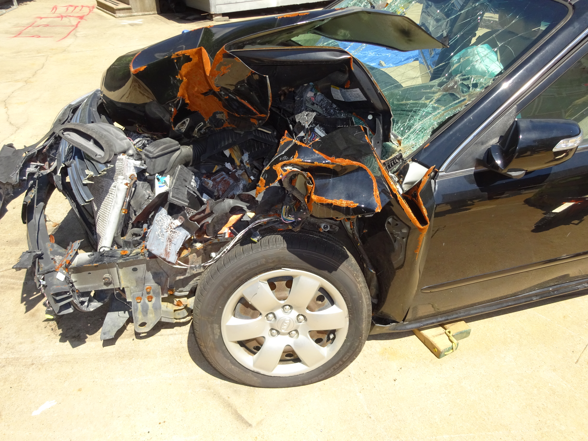 The crushed fender of this 2010 KIA Optima hides everything you need to see for successfully rolling or jacking the dash to free trapped occupants. Moving or removing the fender will provide crews with a clearer picture of the task at hand. Photos by Ron Moore