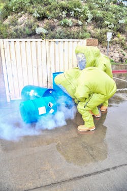 Firefighters use detection devices during a hazmat training exercise. Firefighters use detection devices during a hazmat training exercise.
