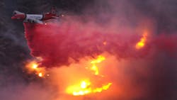 An air tanker drops water on a wildfire in California&apos;s San Fernando Valley in 2008.