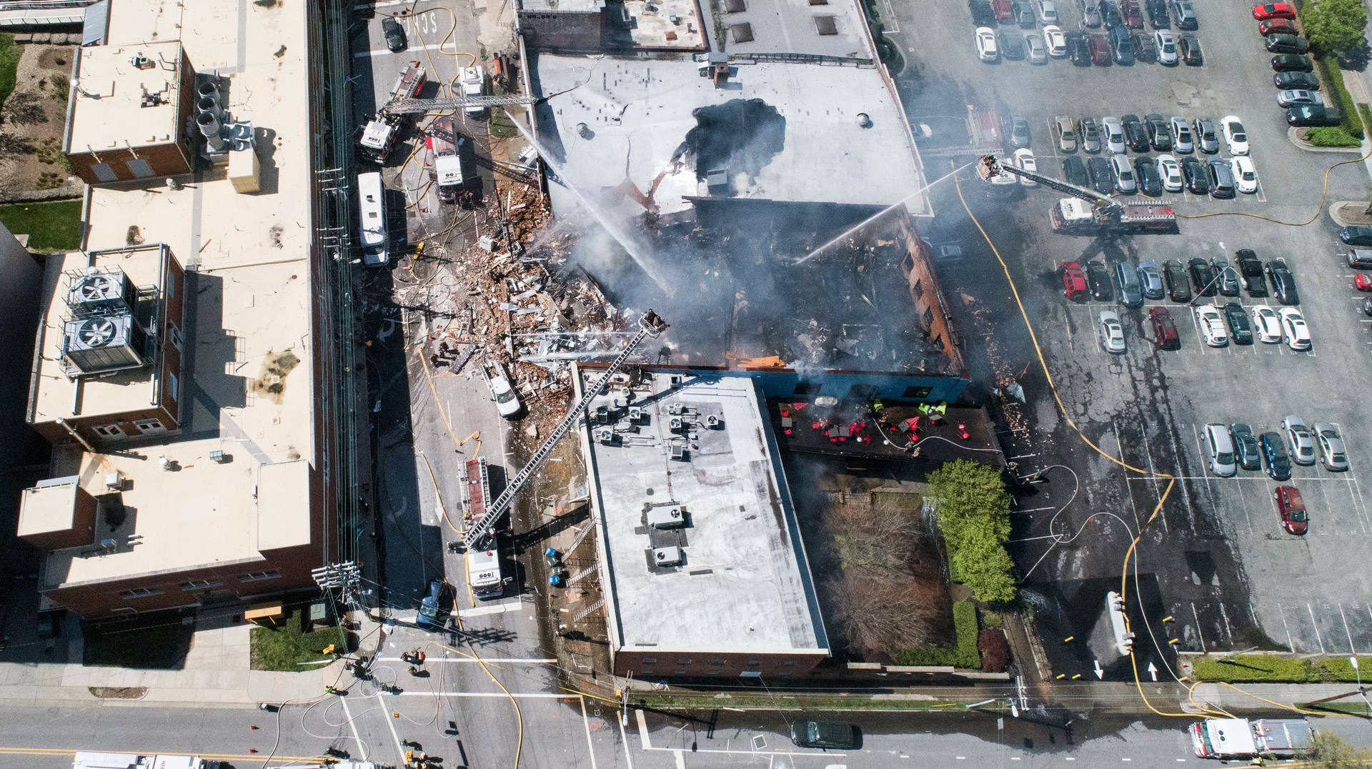 Firefighters fought a building fire after a gas leak lead to an explosion and collapse Wednesday in Durham, NC.