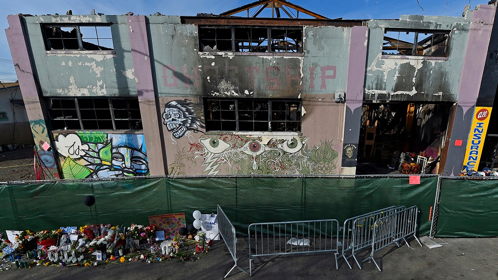 The view outside the scorched Ghost Ship warehouse building in Oakland, CA. The blaze burned through the two-story building, killing 36 people.