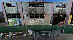 The view outside the scorched Ghost Ship warehouse building in Oakland, CA. The blaze burned through the two-story building, killing 36 people.