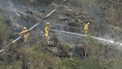 Nearly 50 Honolulu firefighters battled a brush fire Sunday in Kalihi.